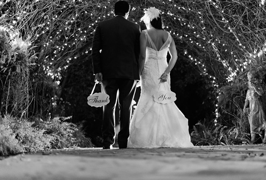 Couple walking away thank you signs