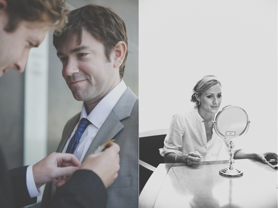 Groom getting boutonniere bride looks in mirror on wedding day