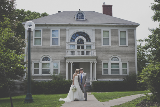 Bride and groom portrait in front of large vintage home