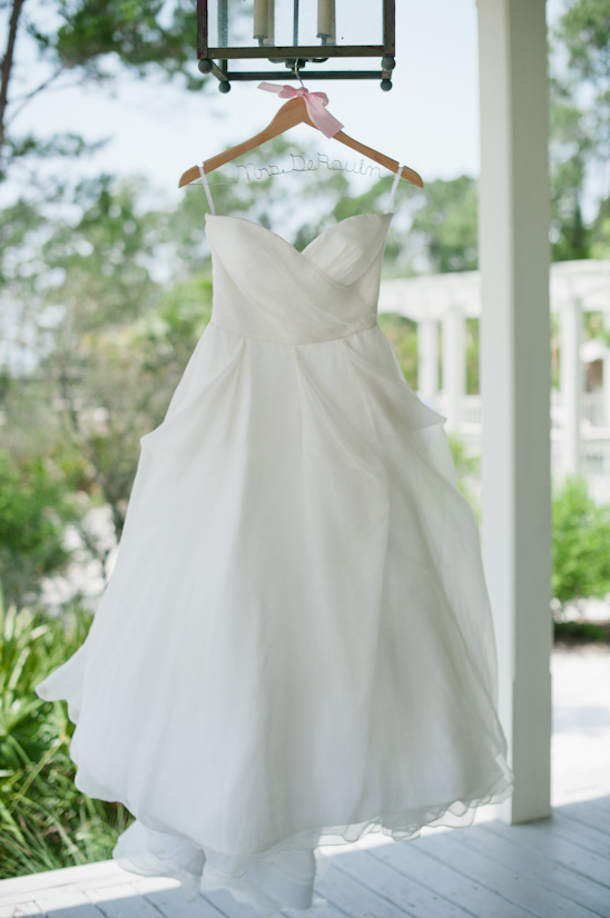 White strapless wedding gown hangs before the big day