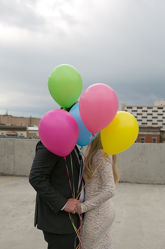 Couple holding colorful balloons