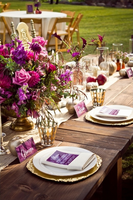 Outdoor wedding table setup with purple floral decorations