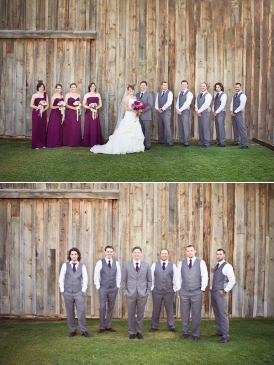 Wedding party poses by rustic barn