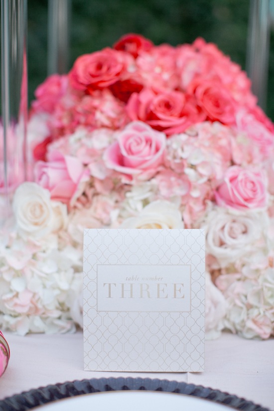 Table number three card on pink roses