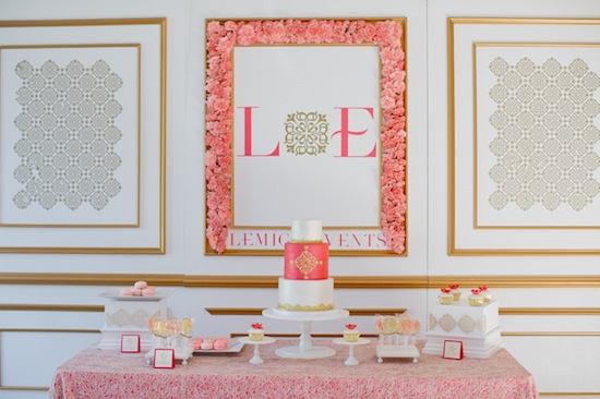 Elegant pink and gold wedding cake display with LE monogram