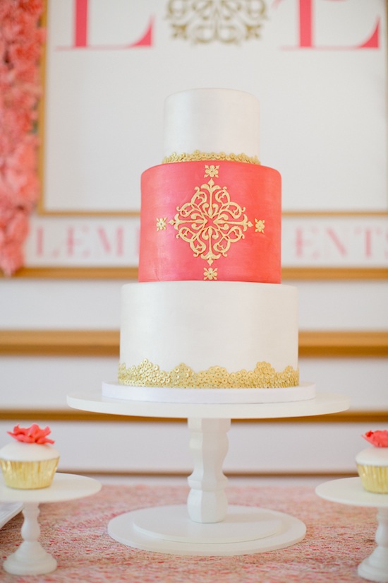 Elegant three-tiered coral and gold wedding cake