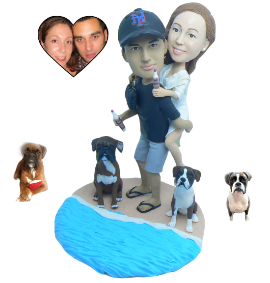 Custom bobblehead figurine of a couple with Boxer dogs on the beach