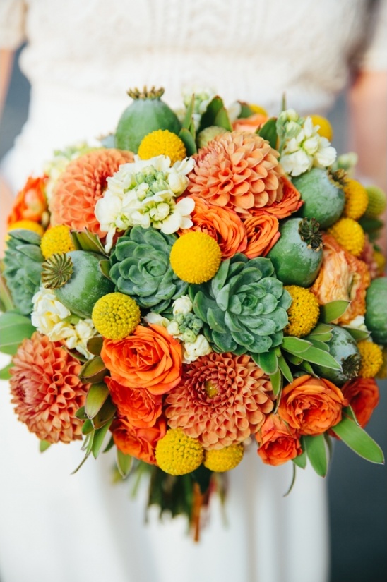 Bright wedding bouquet with orange dahlias and succulents