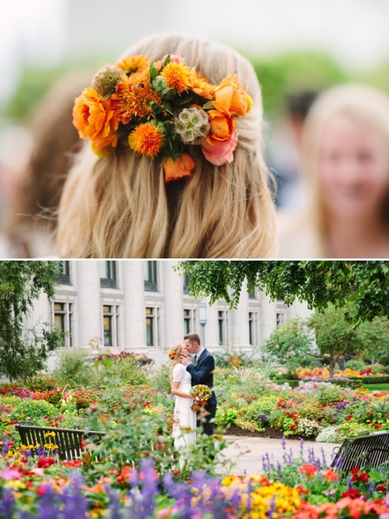 Orange floral wedding hairpiece and couple kissing in garden