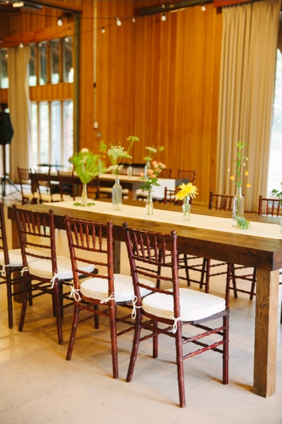 Rustic wedding reception table setting with flowers