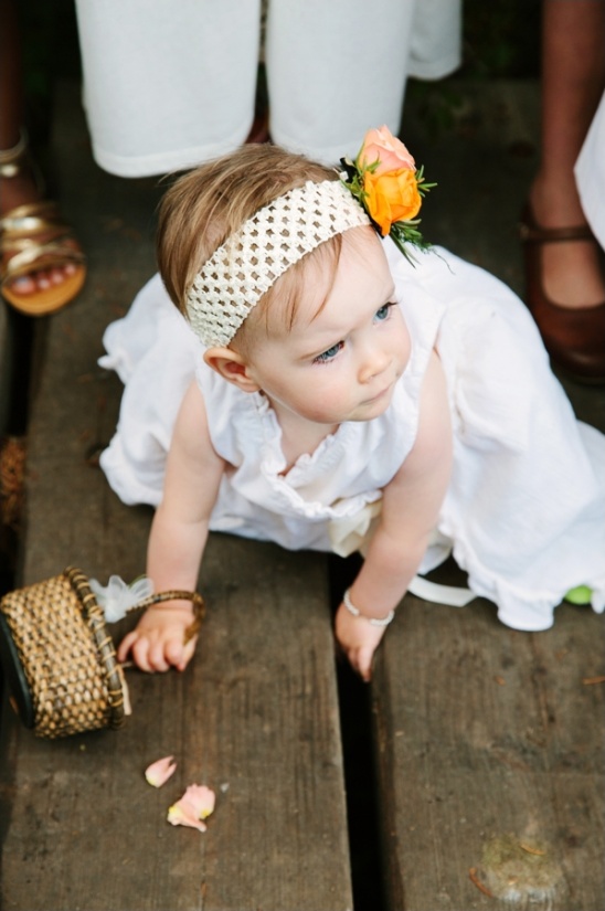 Adorable flower girl in white dress and headband