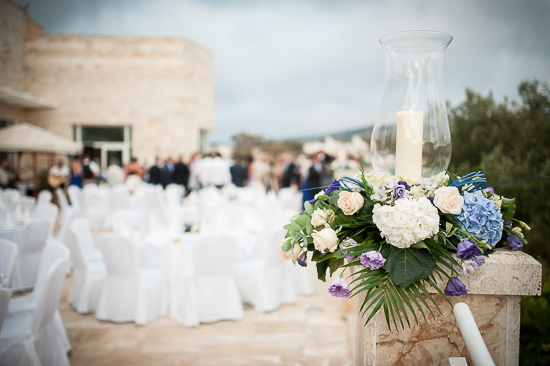 Outdoor wedding reception with floral centerpiece and candle