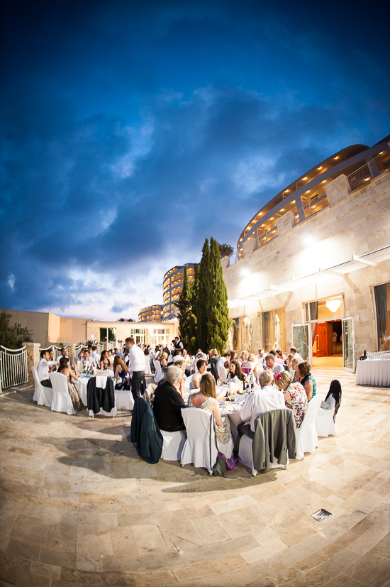 Outdoor wedding reception under a cloudy evening sky