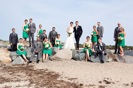Bridal party in green and gray at beach wedding