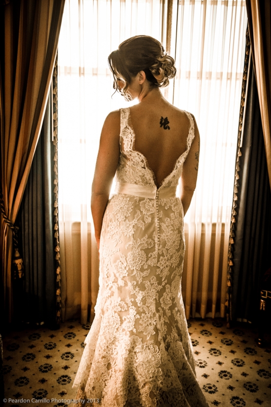 Bride in lace wedding gown, back view