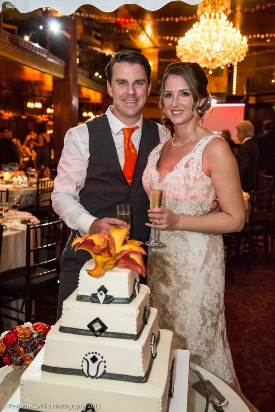 Happy couple with wedding cake and champagne