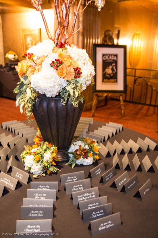 Elegant wedding place cards displayed near floral centerpiece