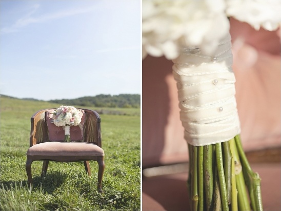 A bouquet of flowers rests on a chair in a grassy field