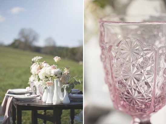Elegant outdoor table setting with flowers and pink glass