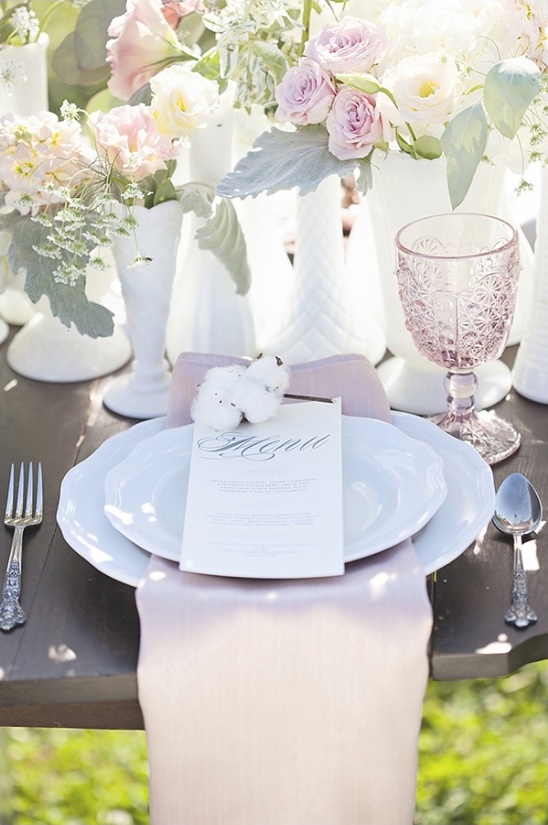 Elegant wedding table setting with flowers and menu