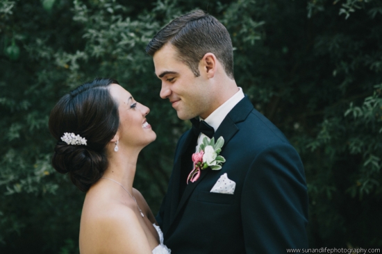 Bride and groom lovingly gaze at each other outside