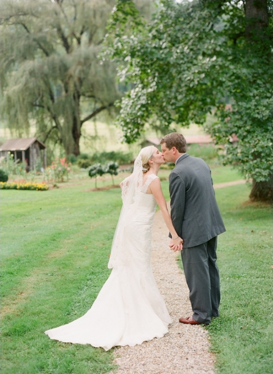 Couple kissing, wedding dress, garden path