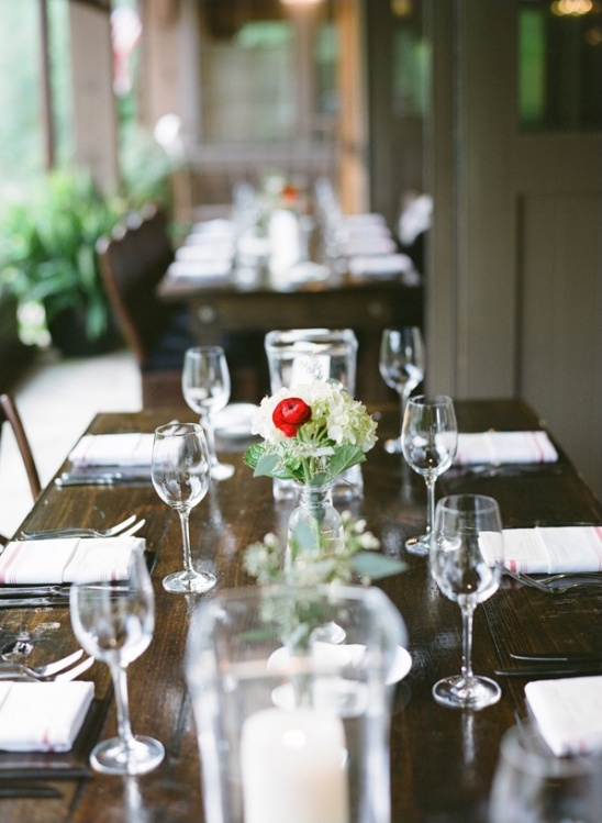 Elegant rustic table setting with wine glasses flowers