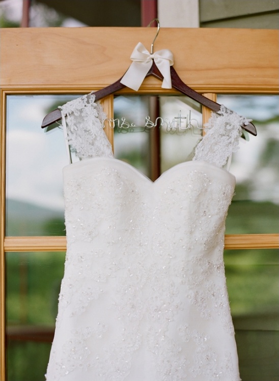 Elegant white wedding dress on a hanger