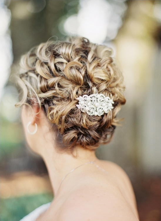 Curly bridal hairstyle with jeweled hair clip