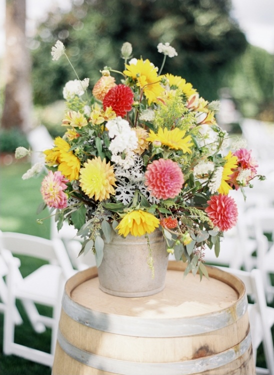 Vibrant floral arrangement on rustic wine barrel table