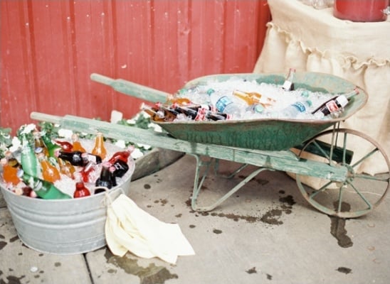 vintage wheelbarrow filled with ice to keep drinks cold