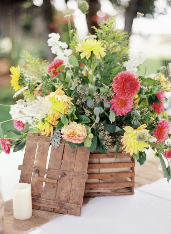Vibrant summer flowers in rustic wooden crate