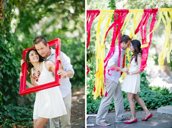 Romantic couple poses with red frame and colorful backdrop