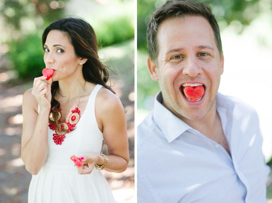 Couple playfully eating heart-shaped watermelon