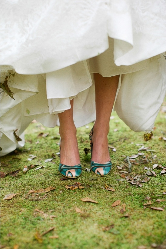 Bride's colorful heels peeking under her white wedding dress