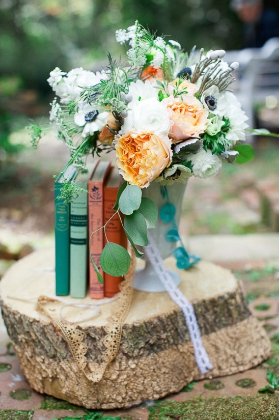 A rustic bouquet with books on a tree stump for decoration