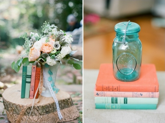 Rustic wedding decor with flowers books and a blue jar