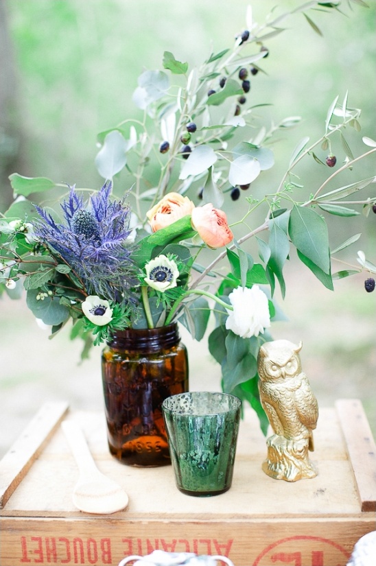 Rustic floral arrangement with owl decor, perfect for a wedding