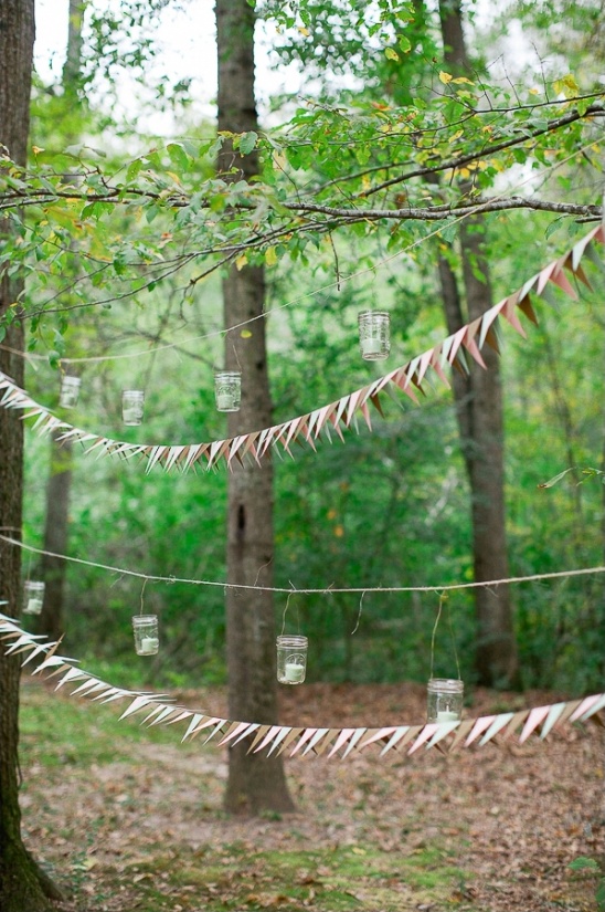 Rustic outdoor wedding decor: mason jar lights & bunting