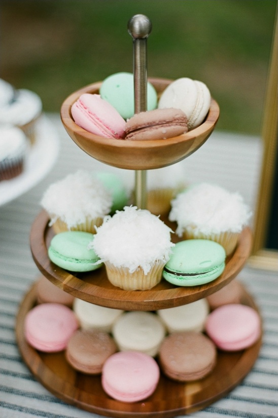 Pastel macarons and cupcakes on tiered stand