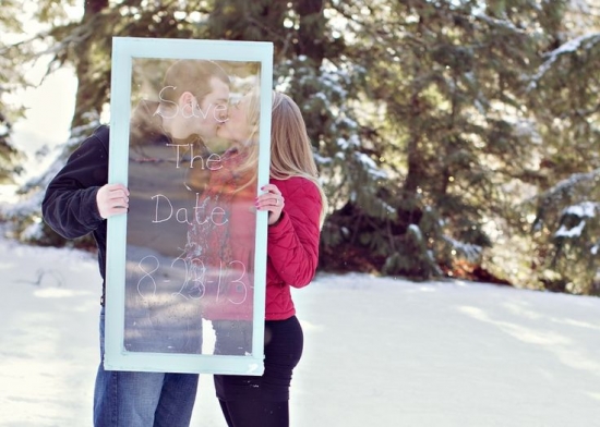 Couple's snowy save-the-date photo with frame