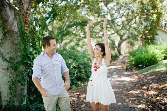Happy couple celebrates with confetti outdoors