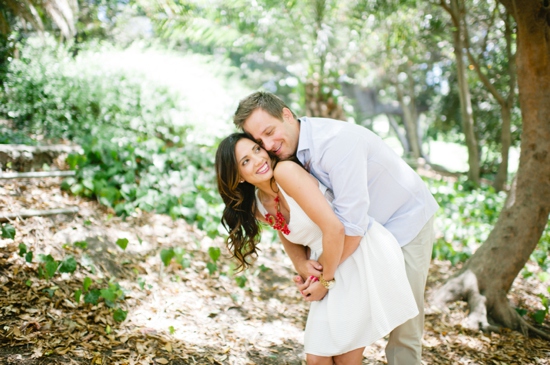 Couple hugging in a forest romantic love scene