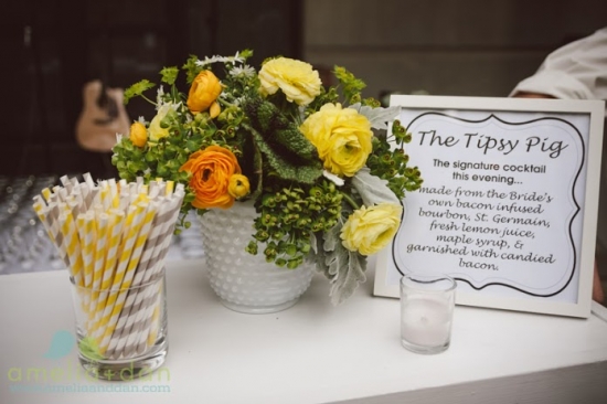 Wedding bar setup with flowers and The Tipsy Pig cocktail sign