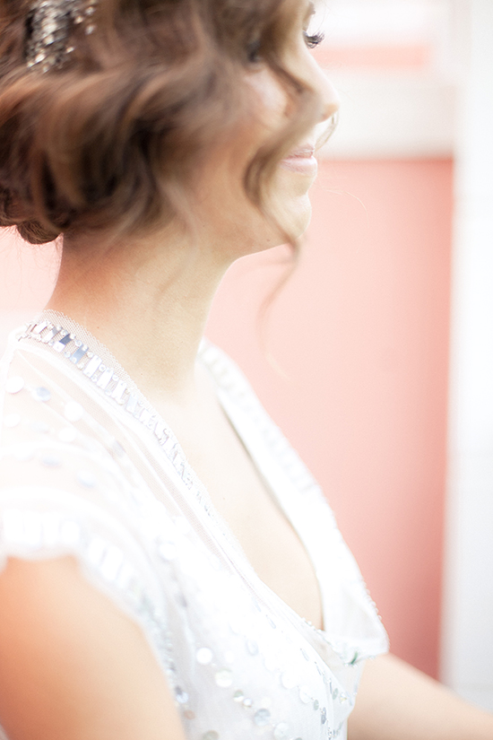 Smiling bride in a white dress with beautiful hair details