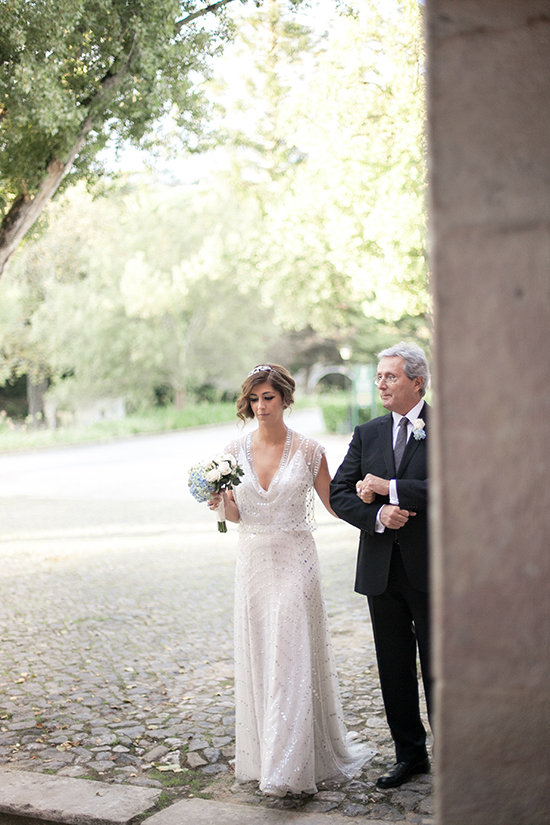 Bride walks with her father down the aisle on wedding day