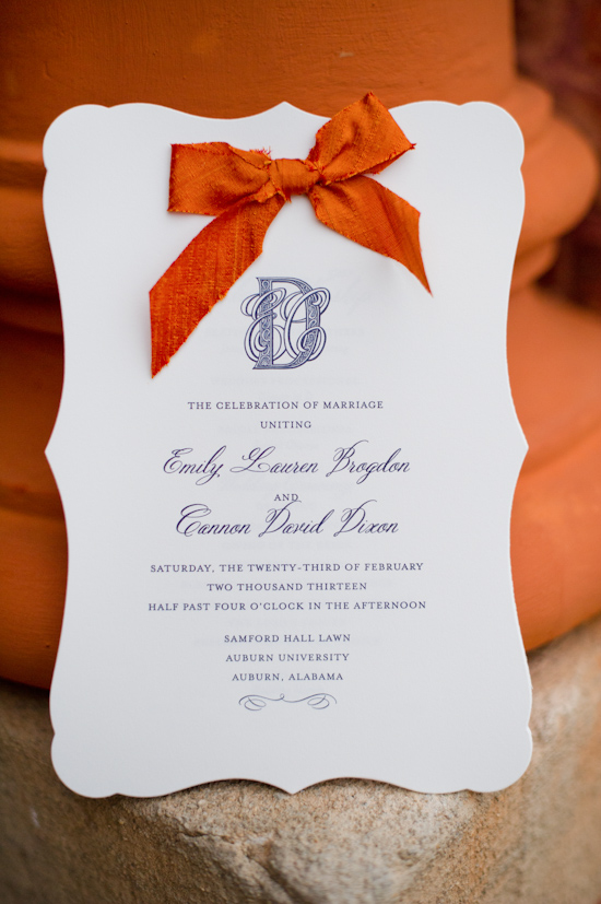 Elegant wedding invitation with orange bow and calligraphy