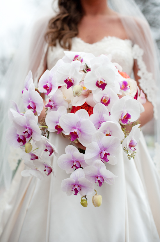 Bride holding beautiful orchid bouquet, wedding day flowers