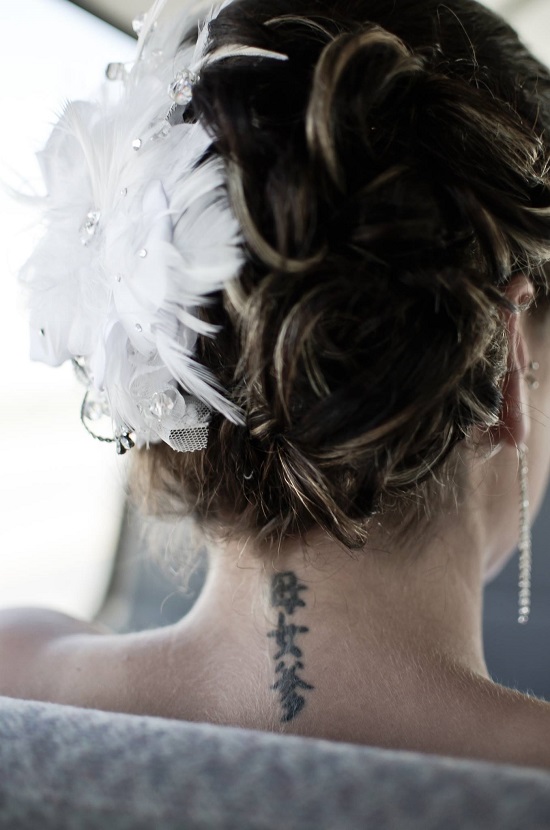 Bride with feathered hair piece and Chinese tattoo on neck