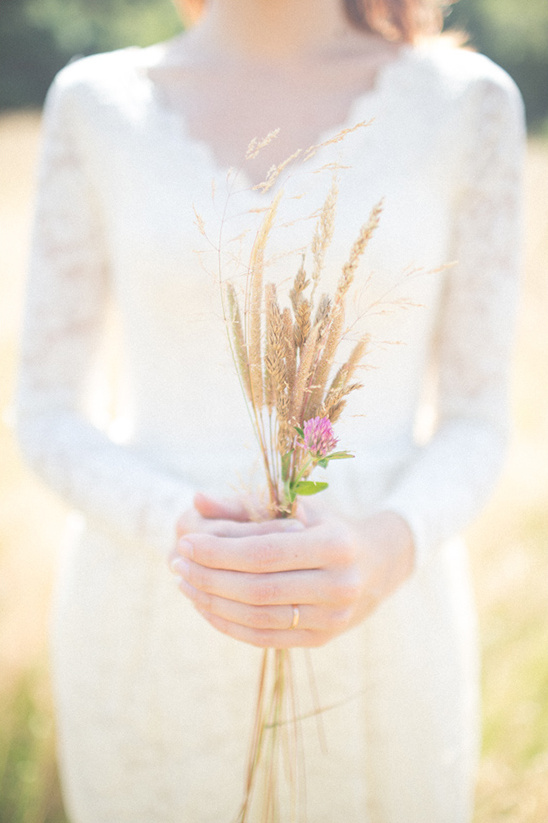 Bride holding rustic dried flower bouquet